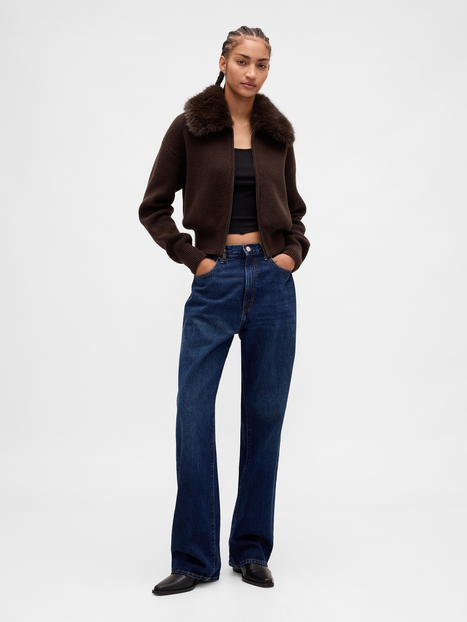 Woman in brown fur coat with cardigan and jeans relaxed look
